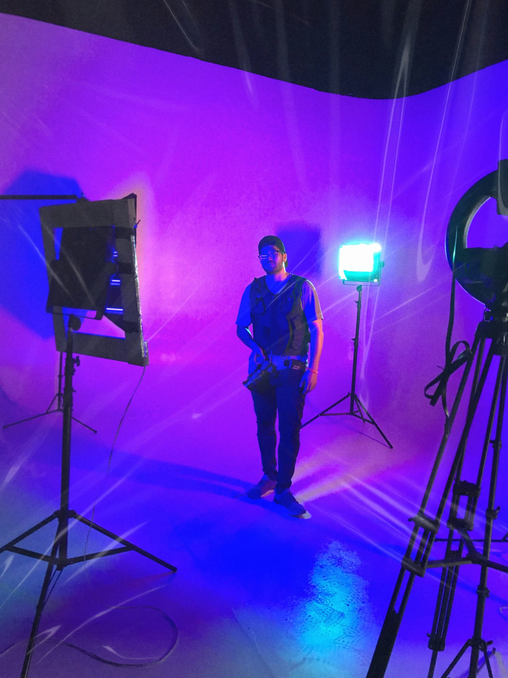 a man stands in front of camera equipment