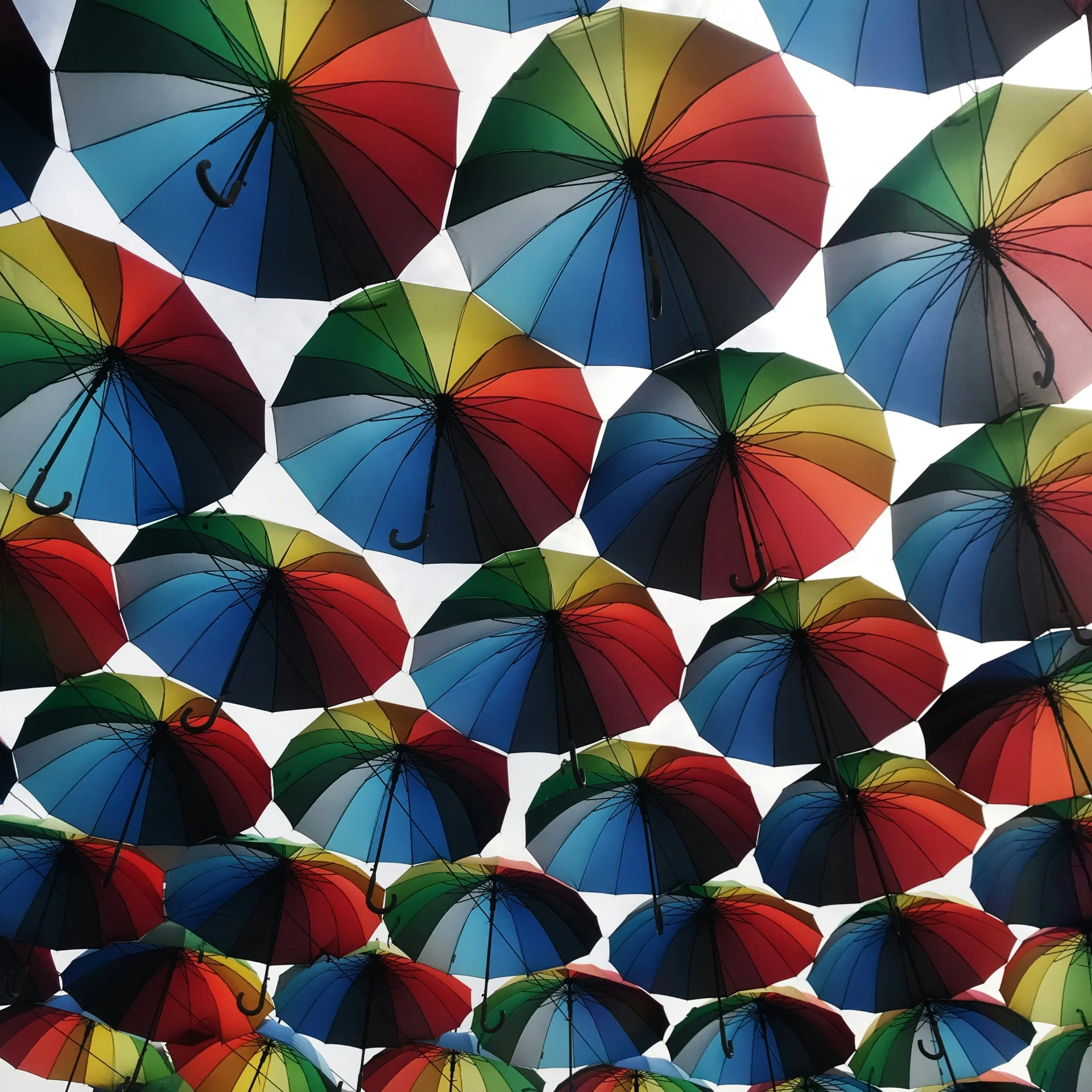 there are multiple colorful umbrellas flying high in the sky