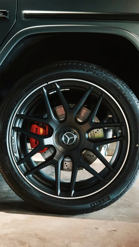 the wheel of a compact four - doored vehicle, on display