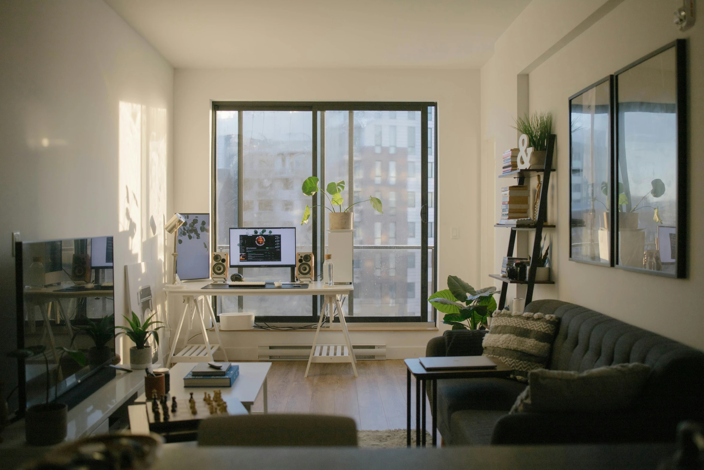 a well lit living room with sofas and tables