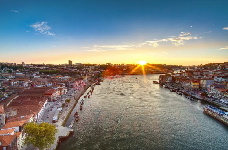 a city that is surrounded by water at sunset