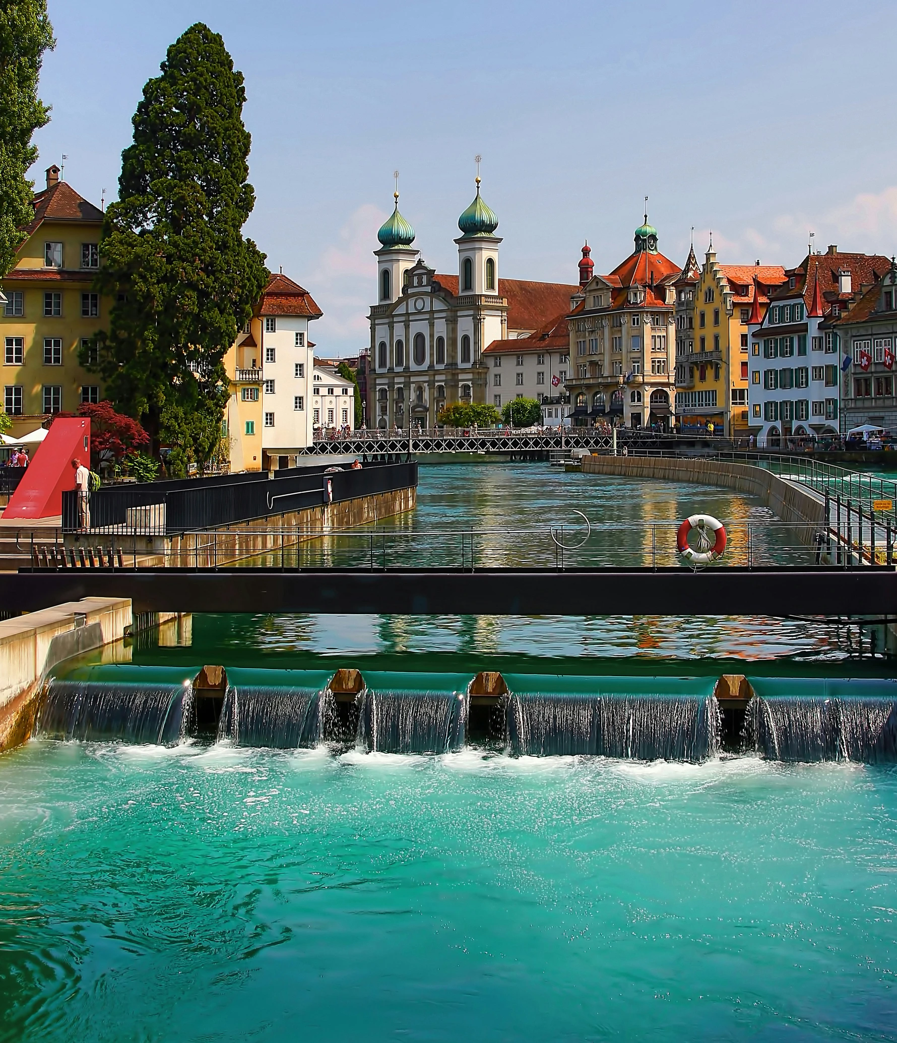 a beautiful blue water canal with buildings and trees around it