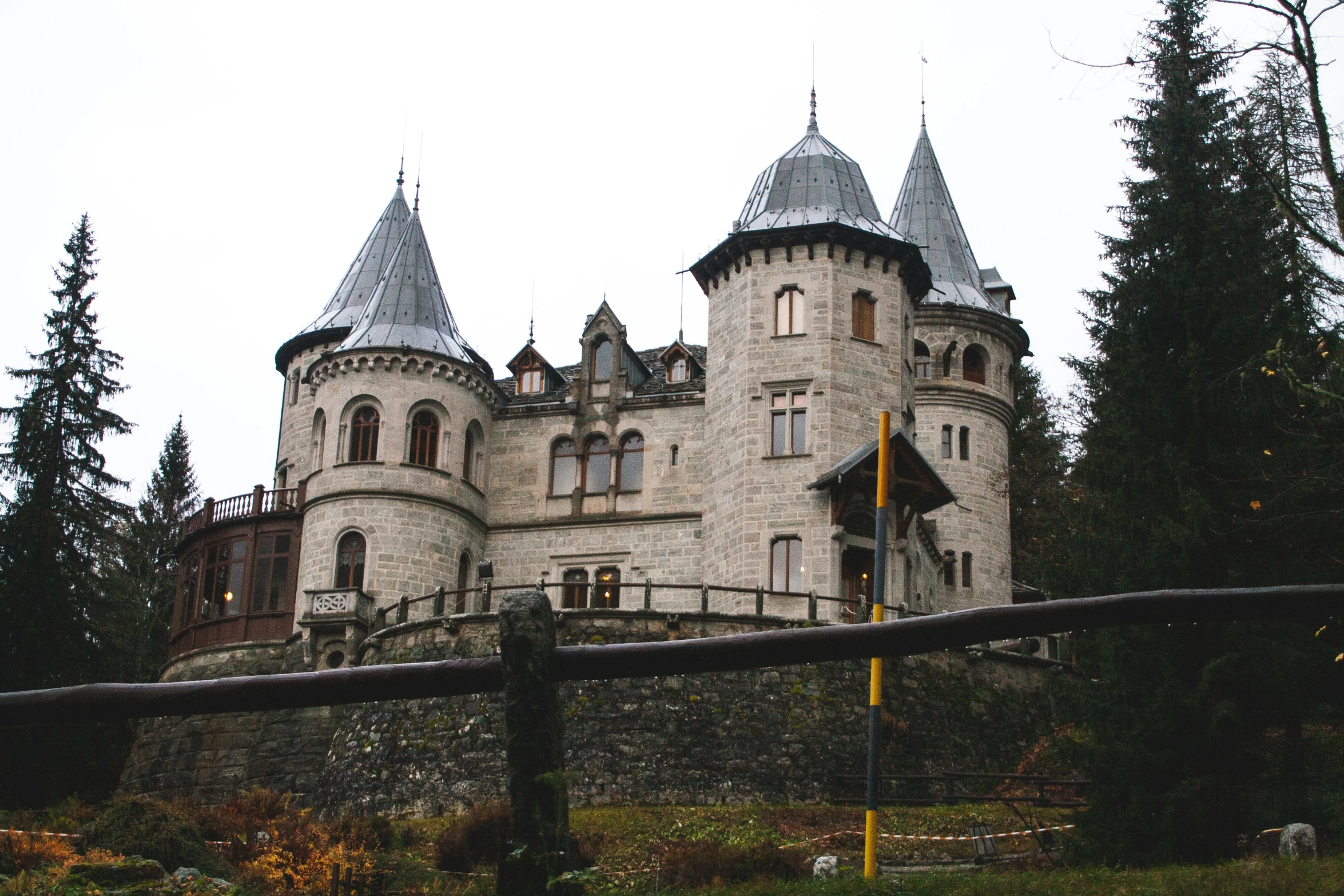 a castle sits in the middle of the woods