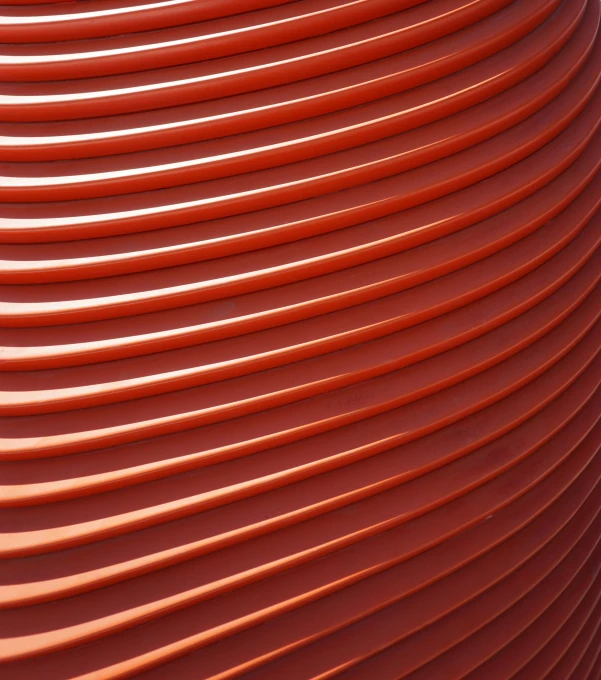 an artistic, large red object made of orange spirals