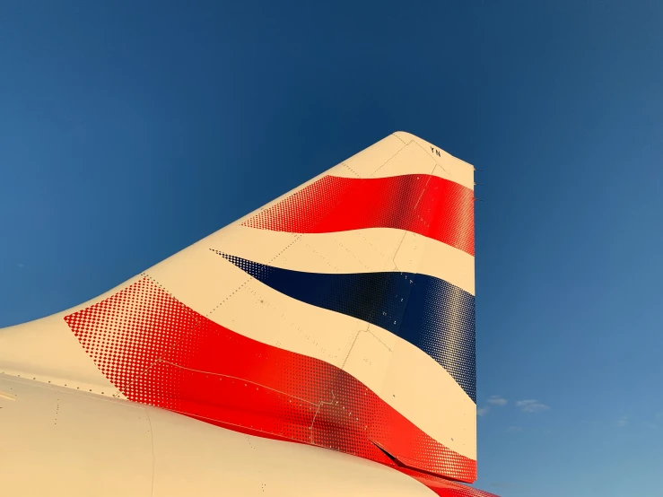 the tail of a white, red and blue airliner