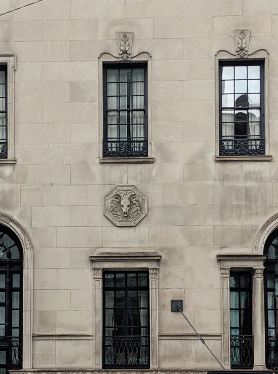 the front of a building with windows and decorative designs