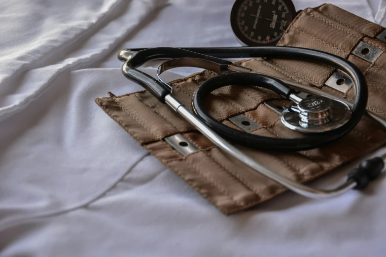 a doctors stethoscope lying on top of a cloth bag