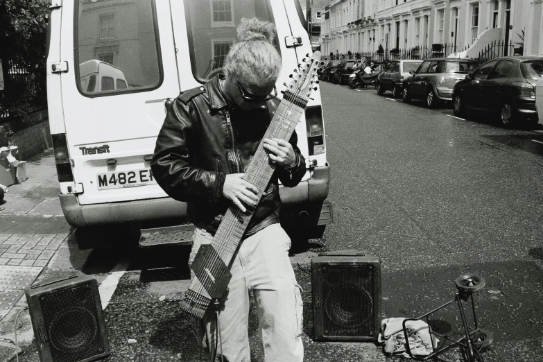 a man playing a guitar on the street