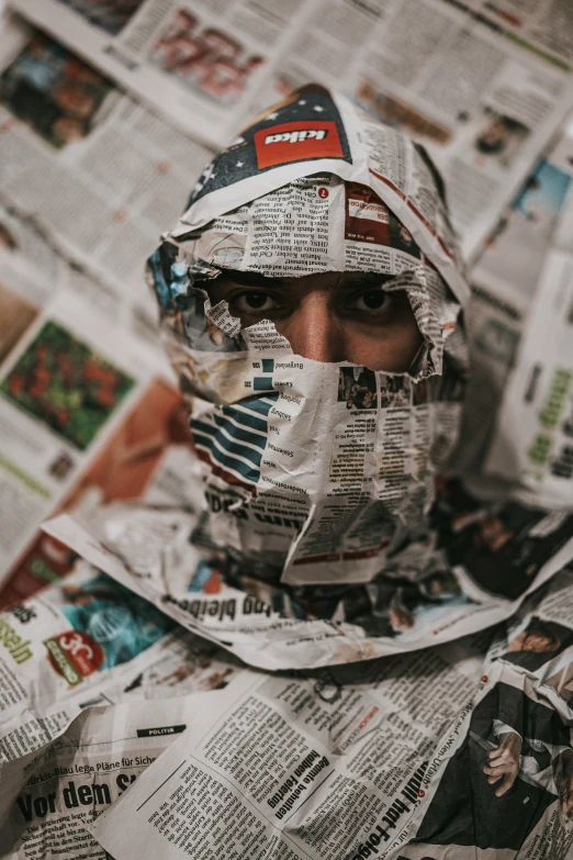 a person with a newspaper covering on their face