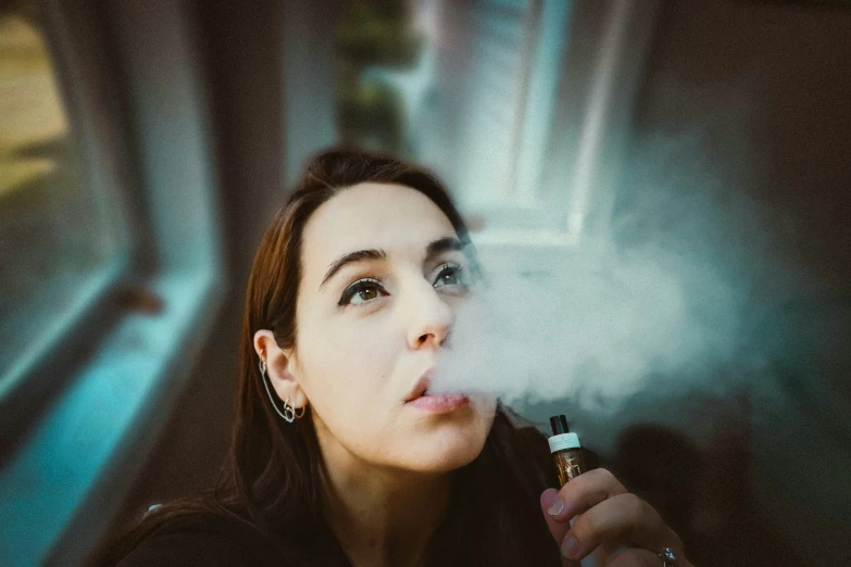 a young woman smoking a cigarette on a bus