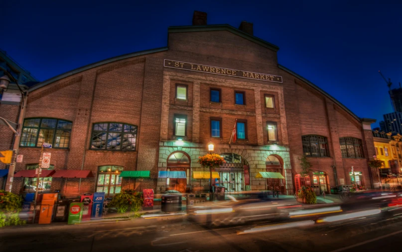 a very large red brick building next to some tall buildings