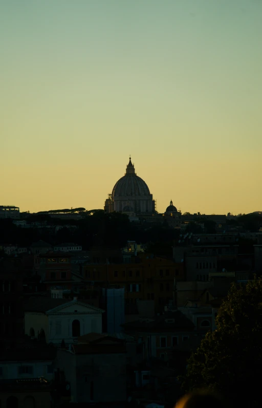 an old italian domed structure rising into the sky at dusk