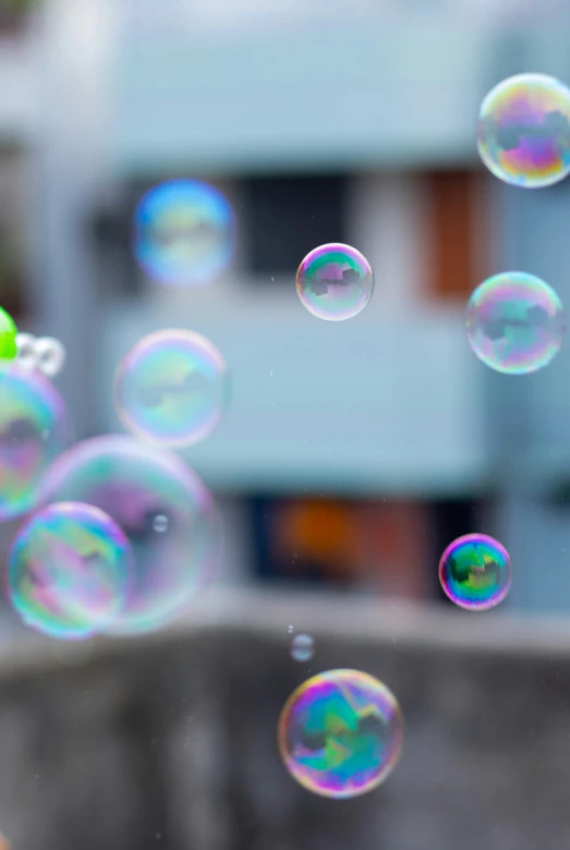 soap bubbles are flying through the air on a window pane