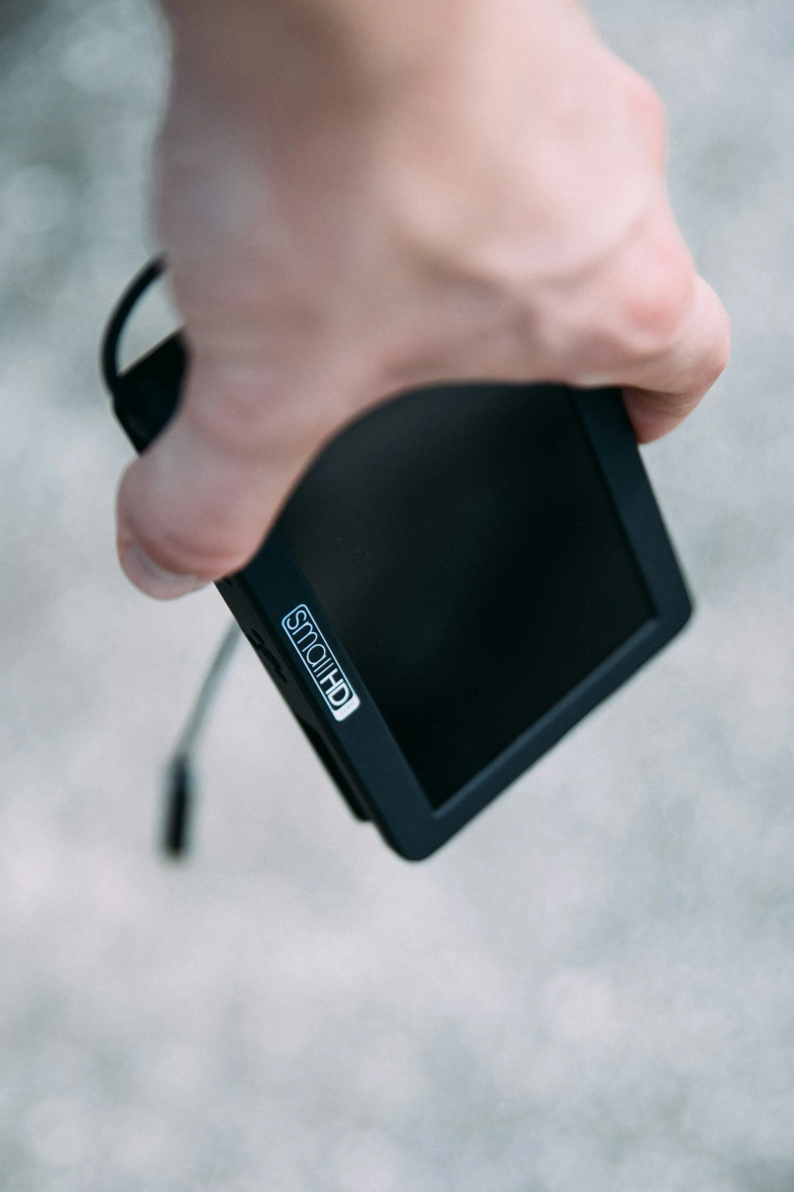 a close - up of a hand holding a small camera