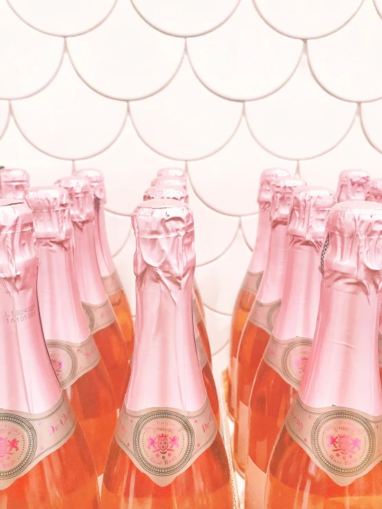 five bottles of pink wine are in an empty display