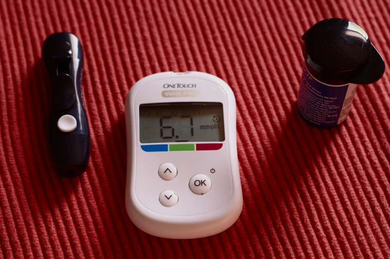 a person's  test, pill bottle and other medicine sitting on a table