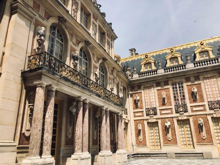 a large building with stone columns and gold decoration