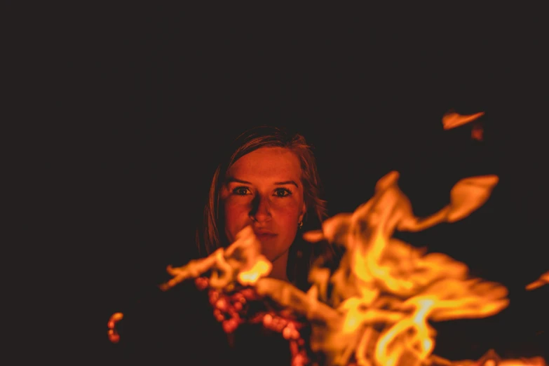 woman in front of a fire and flames