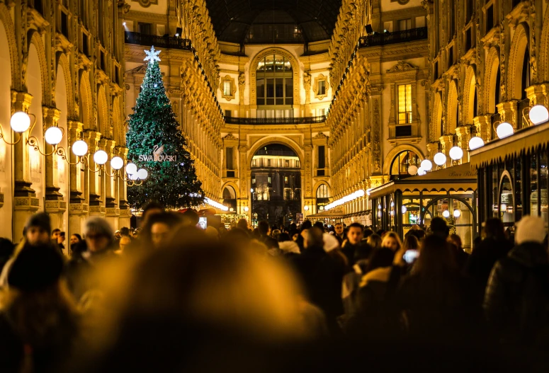 a large christmas tree is shown in this shopping district