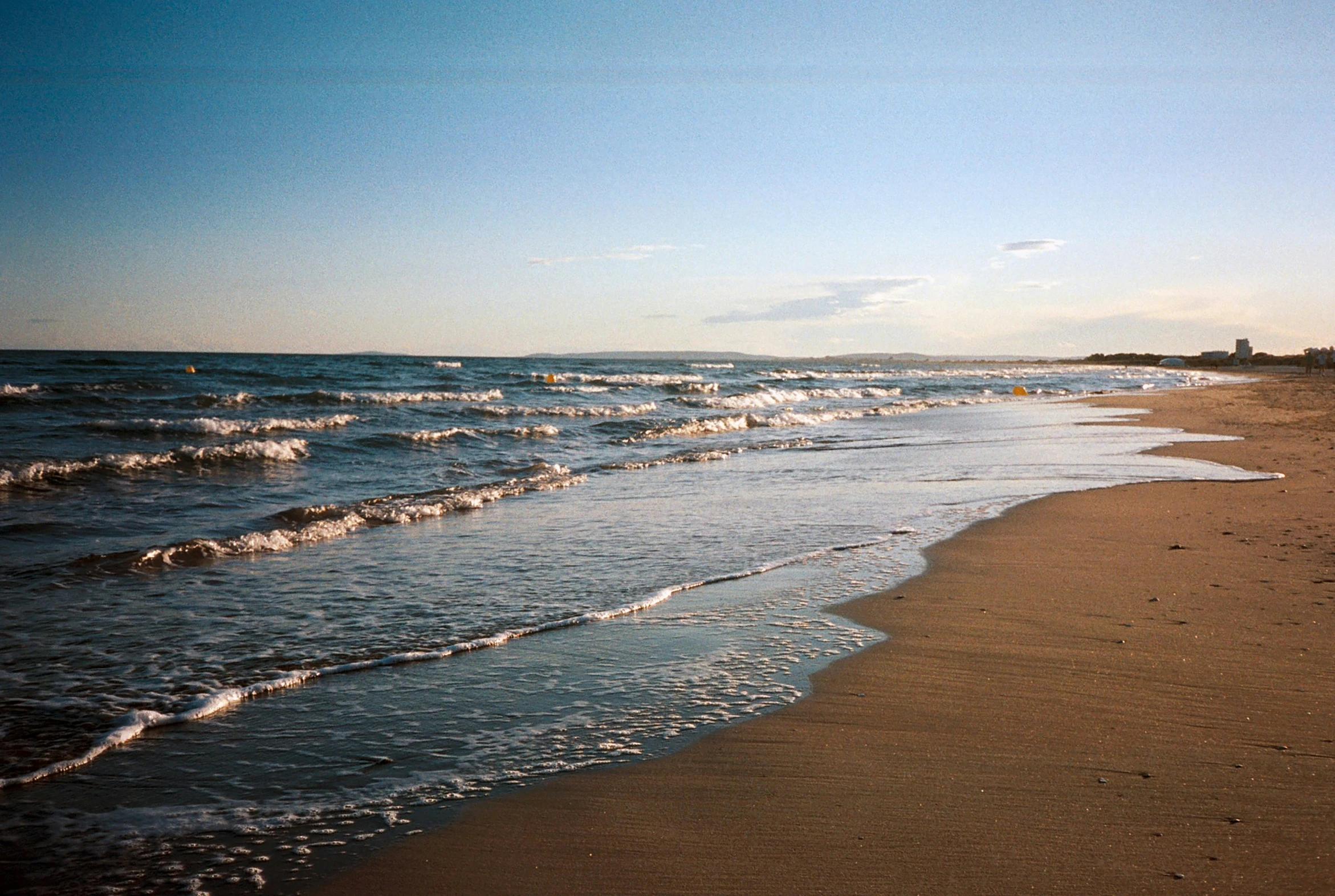 a beach with the ocean coming in to shore