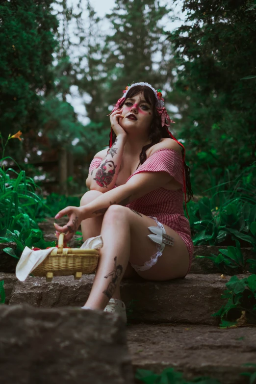 a woman wearing lingerie in woods smoking cigarette