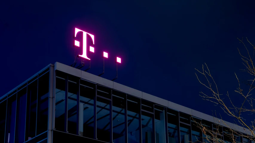 a pink sign is on top of a building