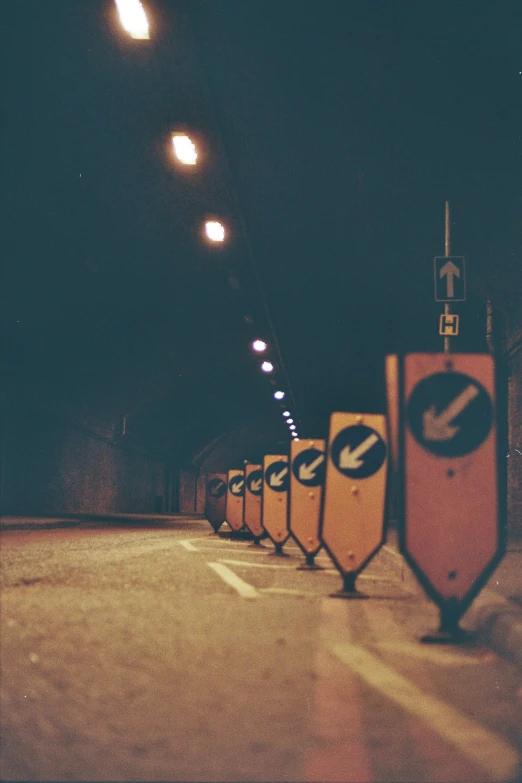 a row of no parking signs sitting on the side of the road