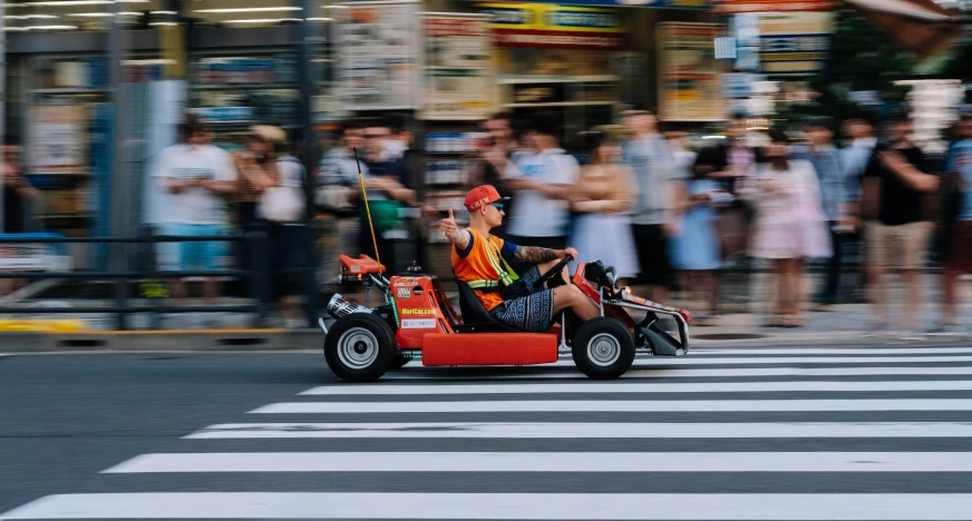 a man driving on the back of a toy car