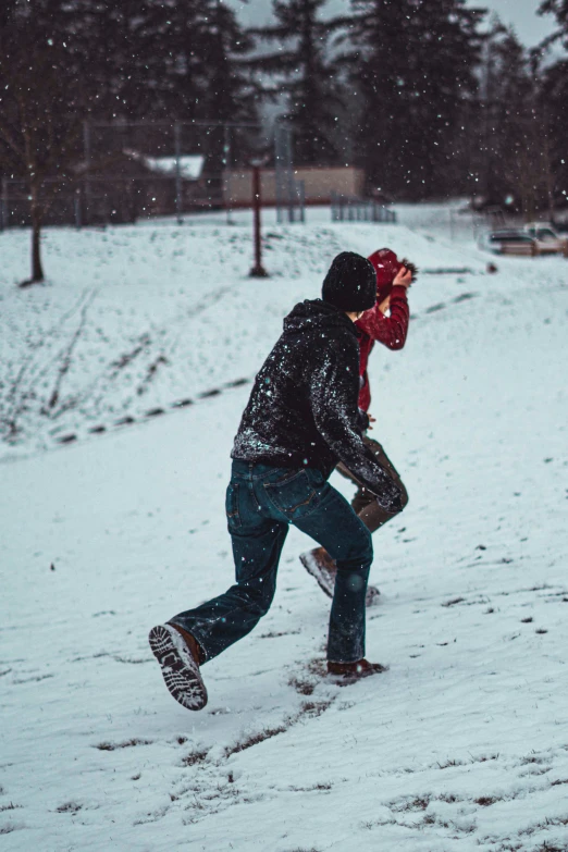 man in winter clothes playing with a frisbee