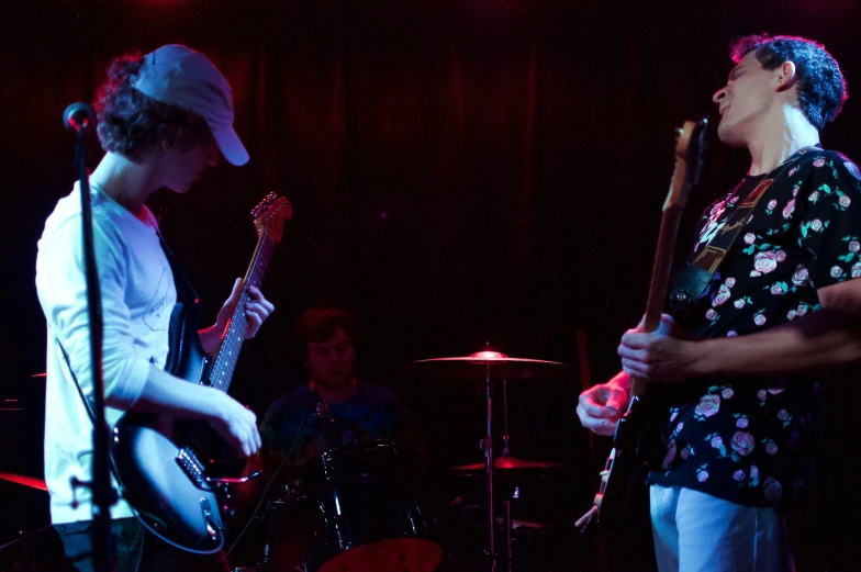 a person with a guitar and another one holding a microphone