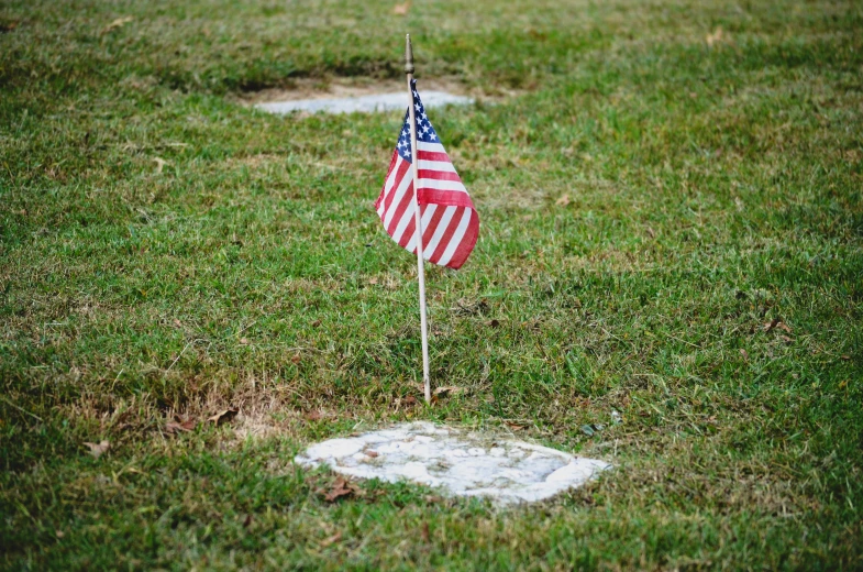 the flag is placed on the side of the grave