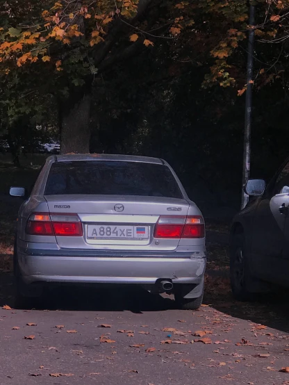 two cars side by side parked on a road