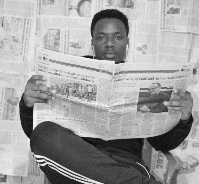 a man reading a newspaper sitting in a chair