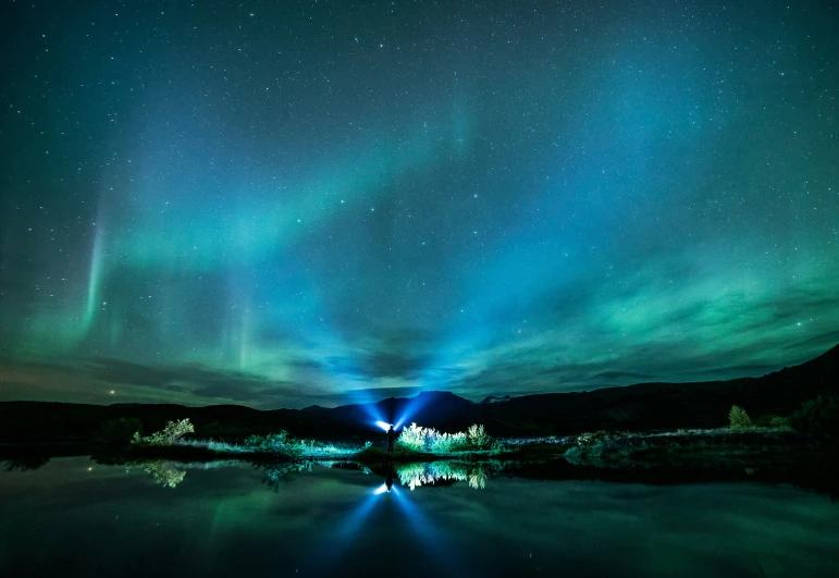 an auroran aurora is visible above a lake