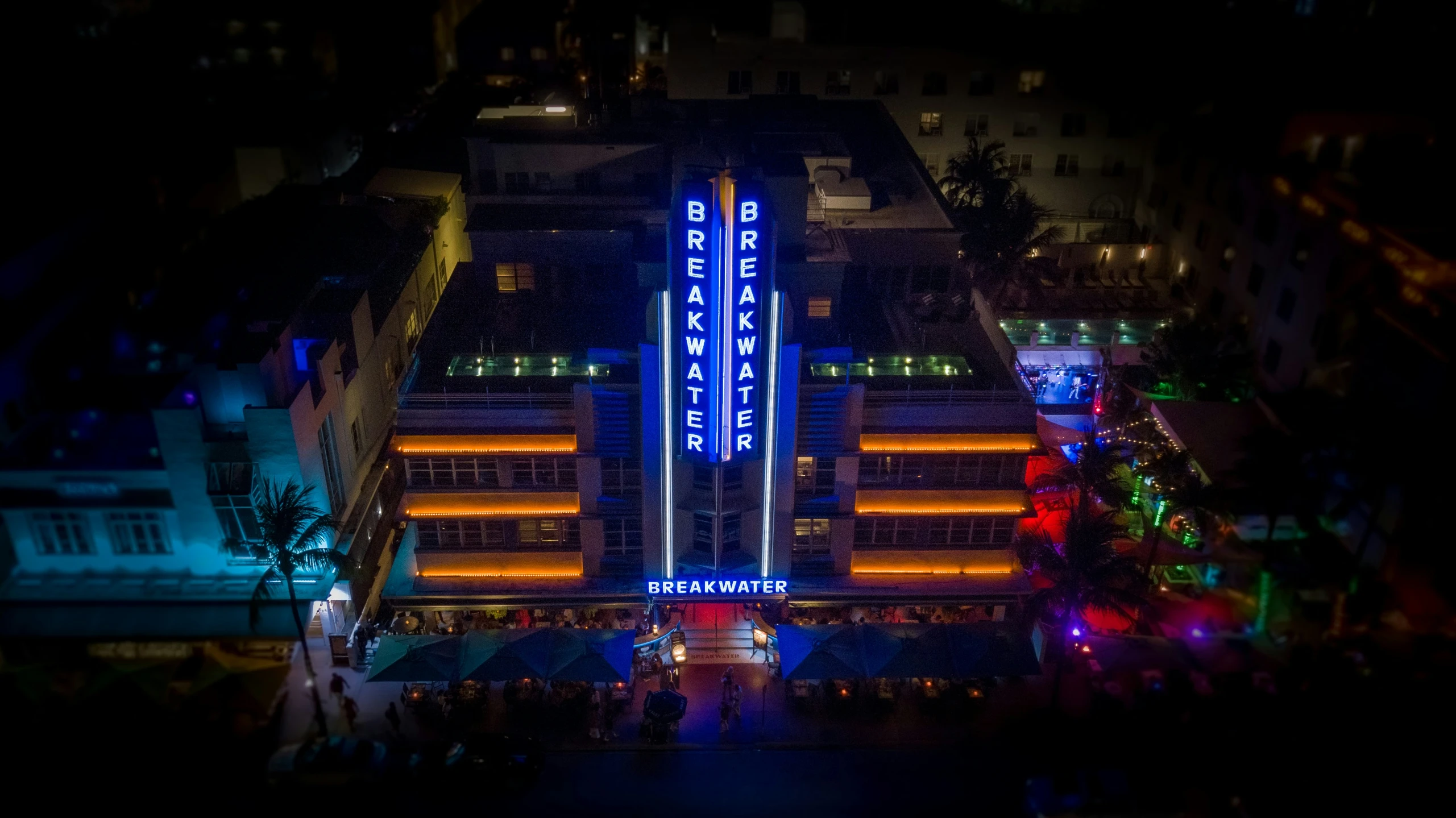 a city at night with a neon building lit up