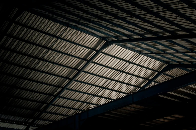 the ceiling inside an airplane hangar is made of dark colored metal