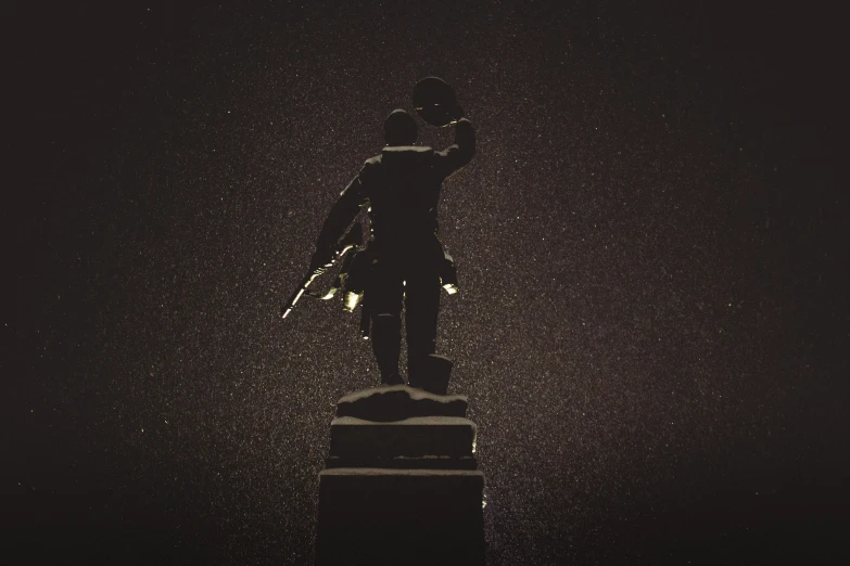 statue on pedestal covered with water at night