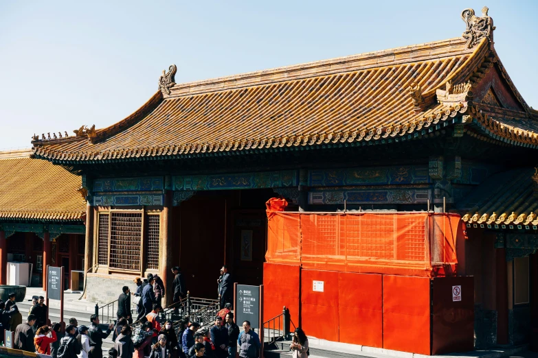 an asian building with lots of bicycles parked next to it