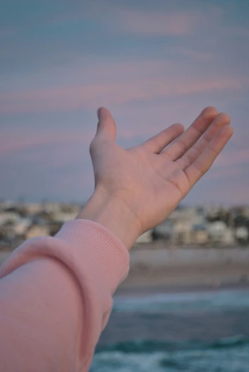 a hand is reaching into the sky to pick up a phone