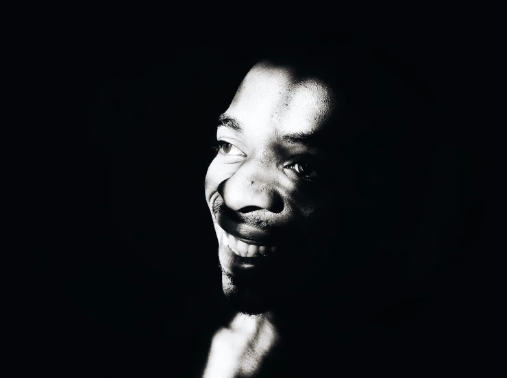 a man with his mouth open smiling in the dark