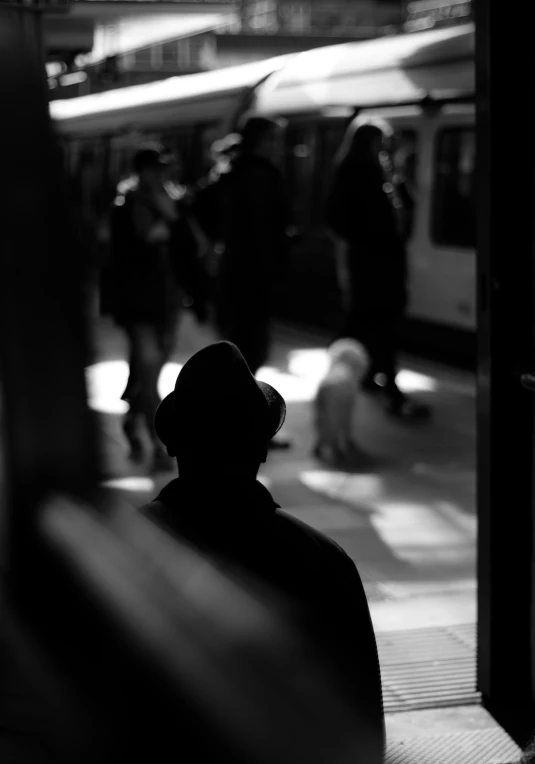 a black and white po of people at a train station