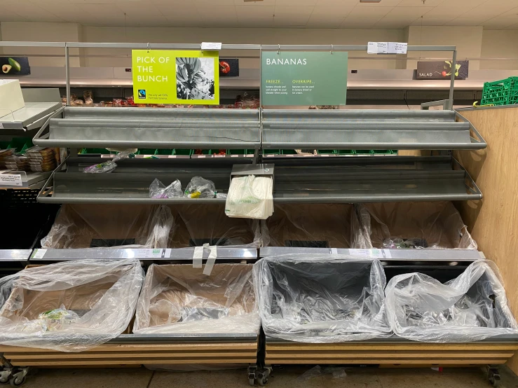 three empty grocery carts in a store filled with supplies