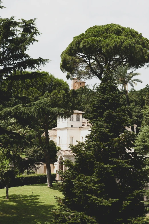 a large building with lots of trees in the middle