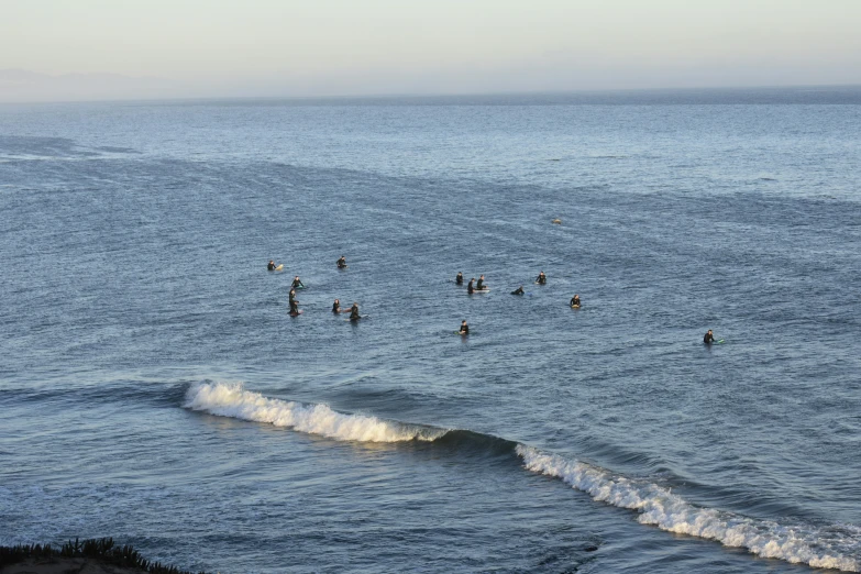 many people in the water at the beach