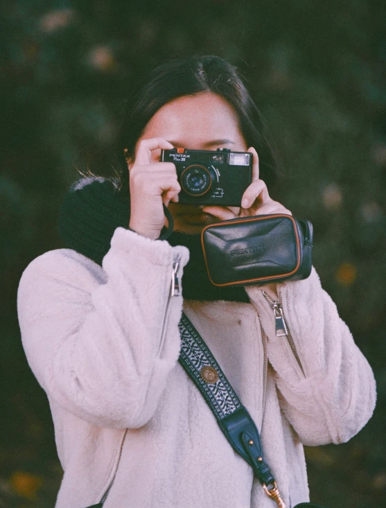 a woman is holding her camera and taking a picture