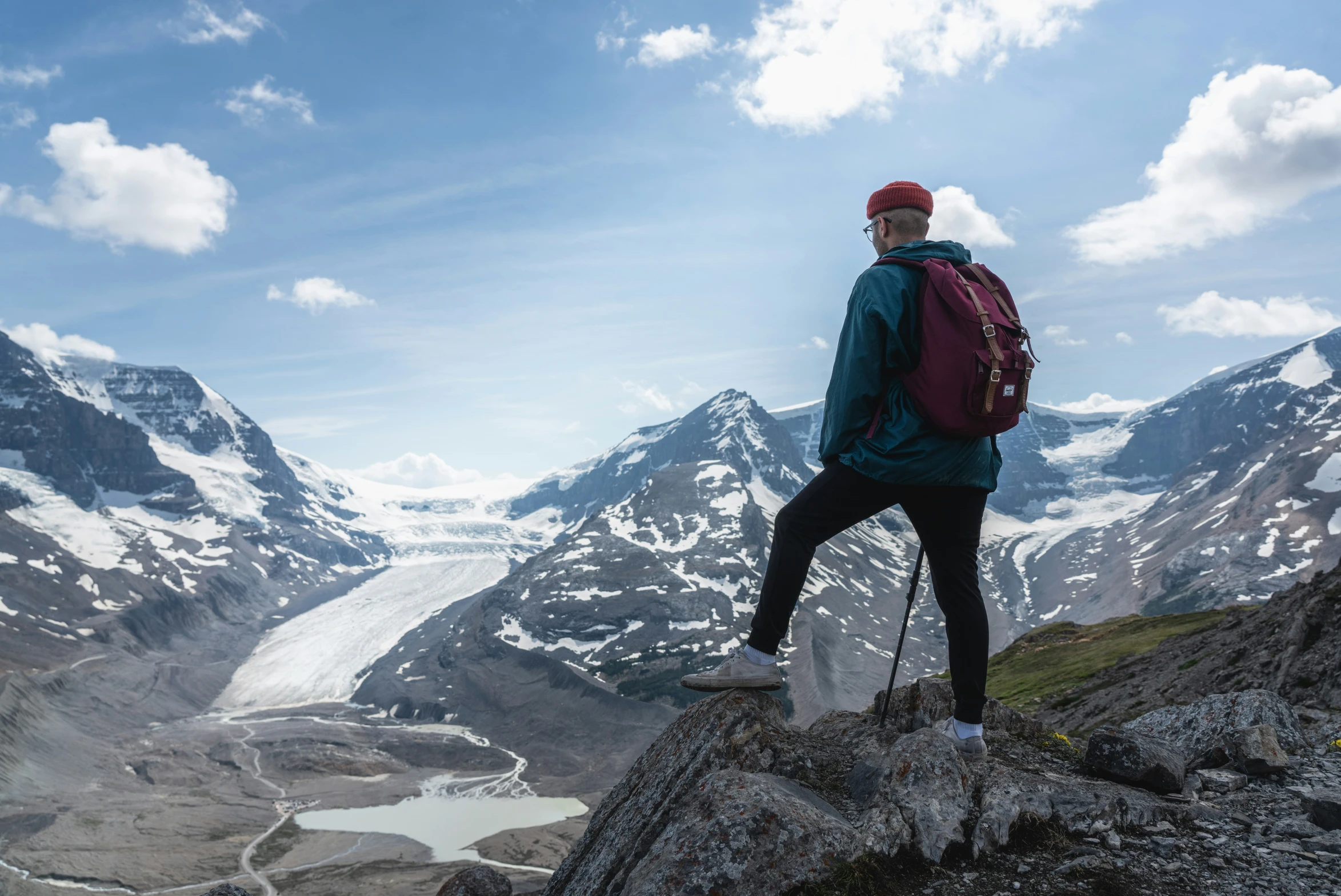 a person wearing a red hat standing on top of a hill