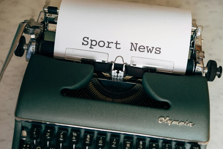 a po of an old typewriter with the word sports news