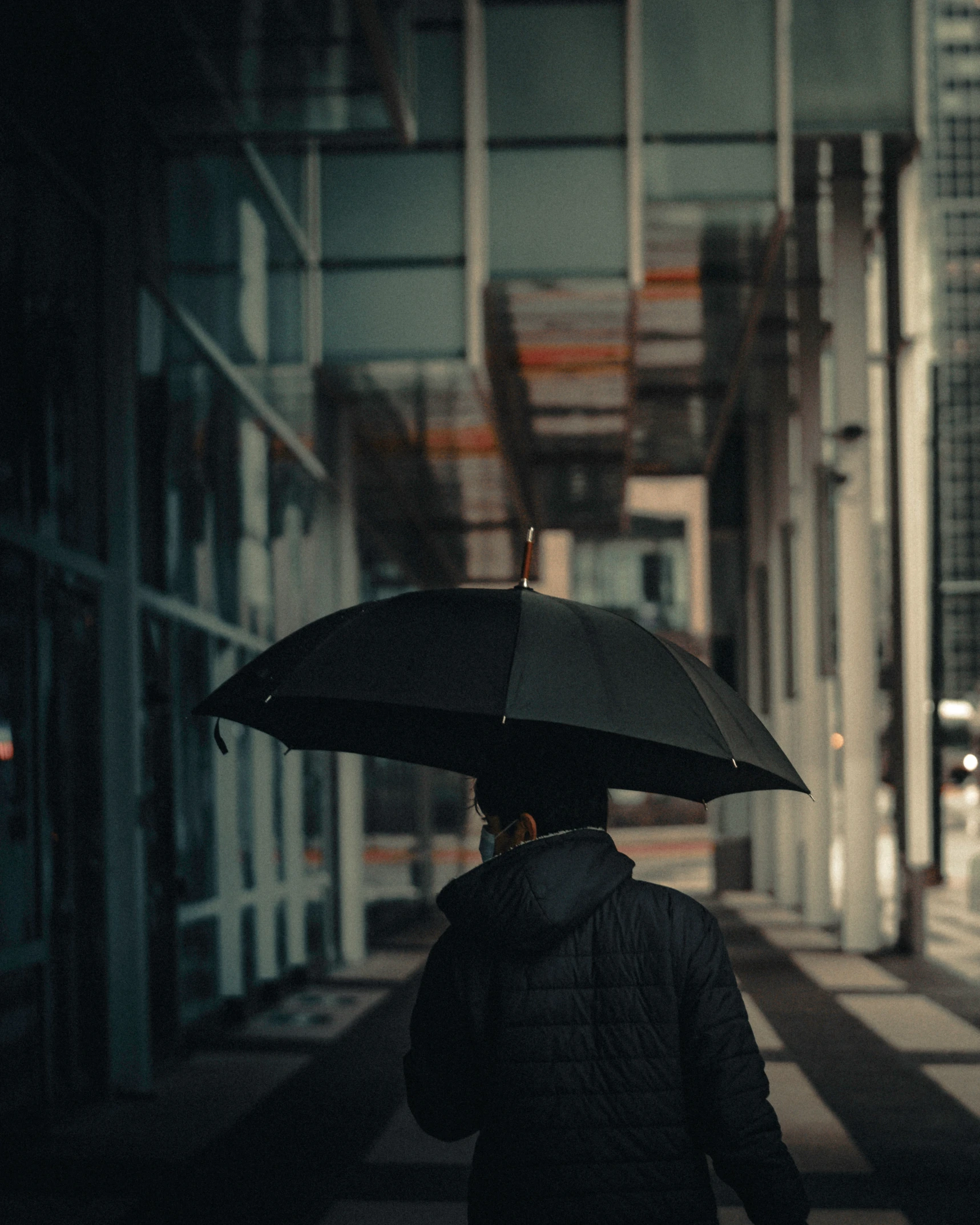 a woman walking down the street with an umbrella