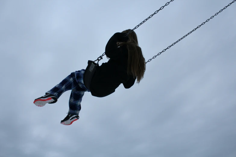 a person holding on to soing while flying through the air