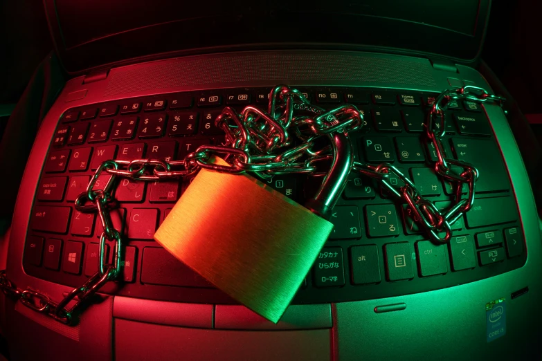 the keyboard is covered with chains and a green lit mug